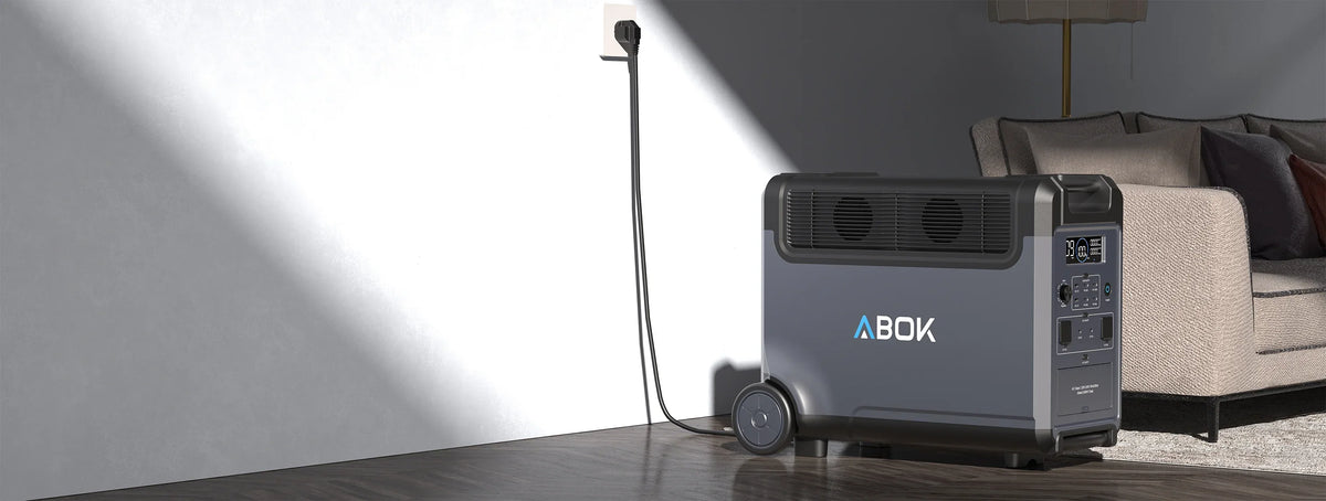 ABOK Ark3600 EU-spec home backup setup beside a sofa with the power station connected to a wall outlet.